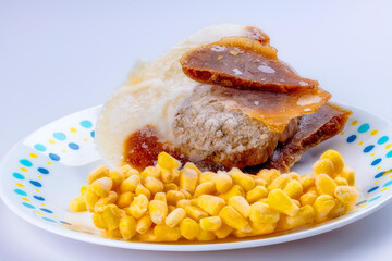 Turkey TV dinner frozen on a white plate