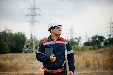 An energy worker inspects power lines. Energy