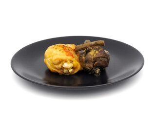 Cooked chicken thigh with roman artichoke isolated on white background