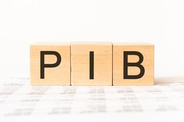 Word PIB. Wooden small cubes with letters isolated on white background with copy space available.Business Concept image.