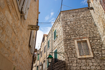 Stari Grad/ Croatia-August 7th, 2020: Beautiful old stone houses in narrow, dalmatian streets of...