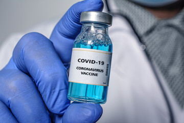 Doctor holds in hand a Coronavirus vaccine that is used for the prevention, immunization and...
