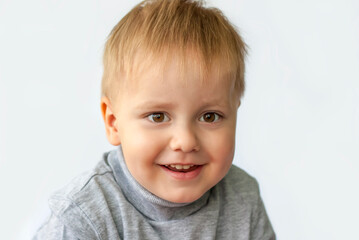 Portrait of an astonished cute little boy. The child is isolated on a white background. Success, bright idea, creative ideas and innovative technological concepts. Concept for an advertising banner.