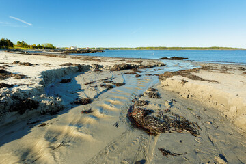 Portsmouth Harbor Lighthouse at Sunset with low tide. Portsmouth Harbor Lighthouse is a historic lighthouse located within Fort Constitution in New Castle, New Hampshire, United States.