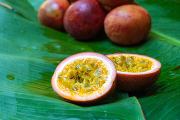Ripe passion fruit, on a wet banana leaf. Vitamins, fruits, healthy foods