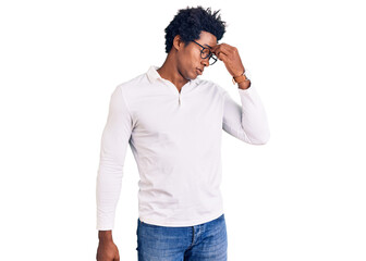 Handsome african american man with afro hair wearing casual clothes and glasses tired rubbing nose...