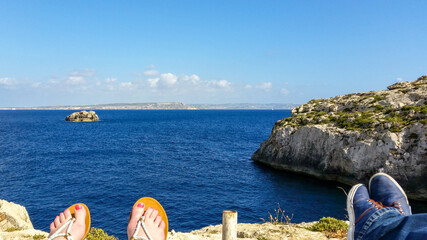Couple rests on a sunny day in Mgarr Ix-Xini, Gozo, Malta