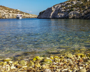 Yacht moored in the narrow Mgarr Ix-Xini bay, Gozo, Malta