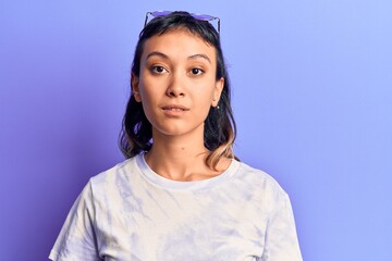 Young woman wearing casual clothes with serious expression on face. simple and natural looking at...
