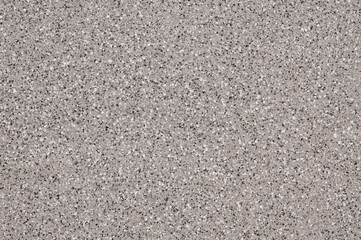 Beautiful facade mosaic plaster, gray with white and dark splashes.