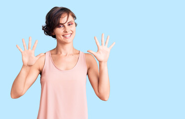 Beautiful young woman with short hair wearing casual style with sleeveless shirt showing and pointing up with fingers number ten while smiling confident and happy.