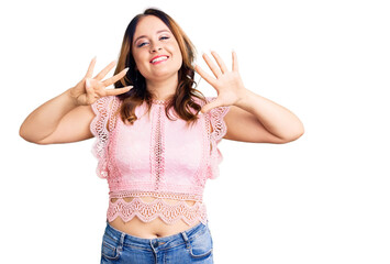 Young beautiful caucasian woman wearing casual clothes showing and pointing up with fingers number...
