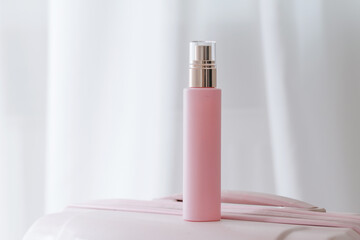 Pink cosmetic bottle on white background. Commercial beauty product photography. Brand package...