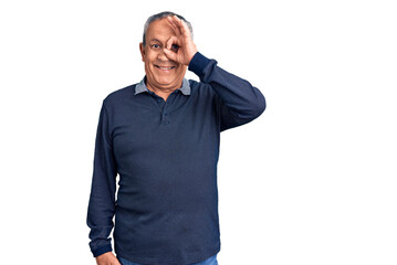 Fototapeta premium Senior handsome man wearing casual polo doing ok gesture with hand smiling, eye looking through fingers with happy face.