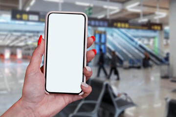 Mock up smartphone in hand closeup, on airport background. Concept on the theme of air travel.