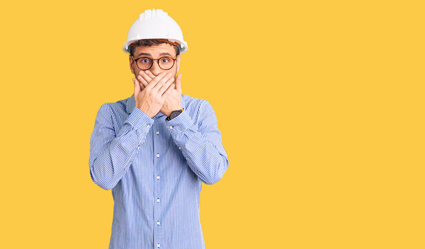 Handsome young man with bear wearing architect hardhat shocked covering mouth with hands for mistake. secret concept.