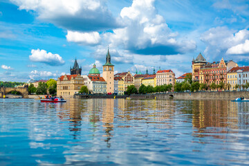 Fototapeta premium The landscape of the city of Prague view from the Vltava river on the ancient architecture of the city