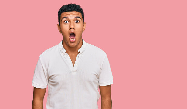 Young arab man wearing casual clothes afraid and shocked with surprise and amazed expression, fear and excited face.