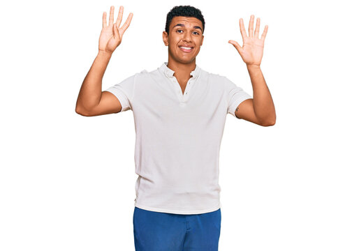 Young arab man wearing casual clothes showing and pointing up with fingers number nine while smiling confident and happy.
