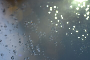 Abstract glitter bokeh on black background. Image with selective focus, noise effect and toning