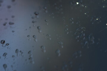 Abstract glitter bokeh on black background. Image with selective focus, noise effect and toning