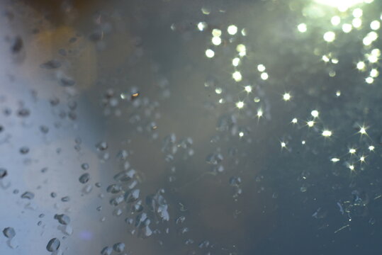 Abstract glitter bokeh on black background. Image with selective focus, noise effect and toning
