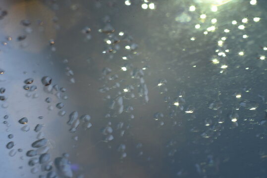 Abstract glitter bokeh on black background. Image with selective focus, noise effect and toning