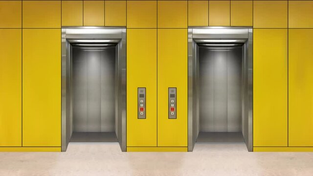 Sliding steel door elevator open showing lift interior. Office building with grey walls.