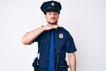 Young caucasian man wearing police uniform cutting throat with hand as knife, threaten aggression with furious violence