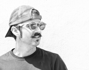 Young man with mustache, cap and glasses	
