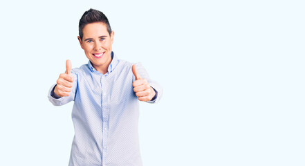 Young woman with short hair wearing business clothes approving doing positive gesture with hand, thumbs up smiling and happy for success. winner gesture.