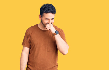 Young hispanic man wearing casual clothes feeling unwell and coughing as symptom for cold or...