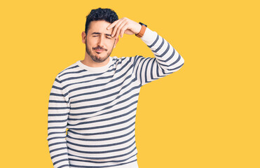 Young hispanic man wearing casual clothes worried and stressed about a problem with hand on forehead, nervous and anxious for crisis