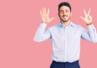 Young hispanic man wearing business clothes showing and pointing up with fingers number eight while smiling confident and happy.