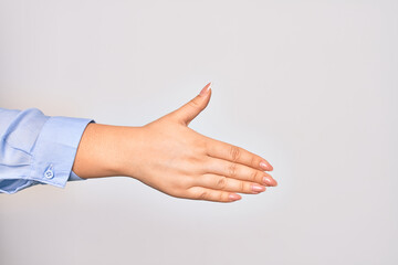 Hand of caucasian young businesswoman doing handshake sign over isolated white background