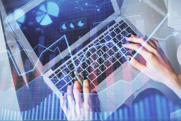 Double exposure of woman hands working on computer and forex chart hologram drawing. Top View. Financial analysis concept.