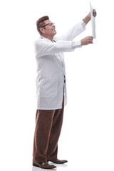 male doctor looking at an x- ray of a patient. isolated on a white