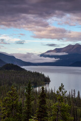 Beautiful View of Muncho Lake in the Canadian Northern Rockies during a cloudy sunrise. Taken in British Columbia, Canada. Nature Background