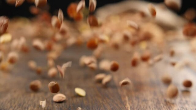 Falling of raw legumes on table, closeup