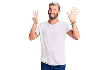 Young handsome blond man wearing casual t-shirt showing and pointing up with fingers number eight while smiling confident and happy.