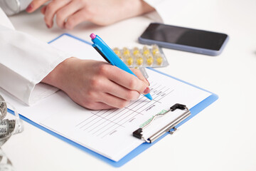 Close up on female hand writing diet plan