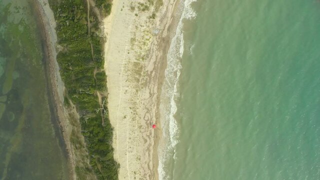 Aerial shot Cape of Rodon Albania. Drone video camera parallel to the rocks and the sea where the waves crash against the rocky shore with beautiful lines and beautiful landscape. Video background.