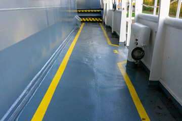 Safety walkway on ships deck. Yellow line walkway. Guided walkway on board. Passenger / contractor footpath on board offshore vessel.