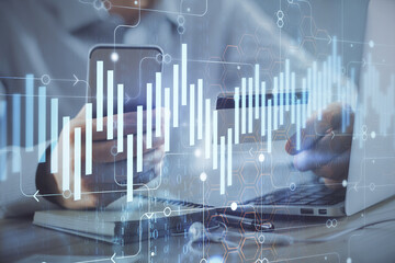 Double exposure of man hands holding a credit card and Forex graph drawing. Stock trading and digital fintech in Internet E-commerce concept.