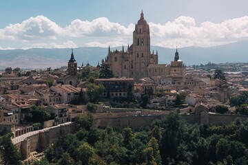 Fototapeta na wymiar Panoramic view of the historic center of Segovia and its Cathedral from the Alcazar of that town in Spain
