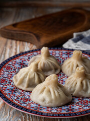Yummy and juicy georgian khinkali on eastern oriental plate
