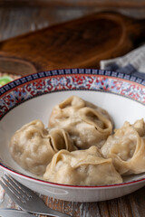 Close up of appetizing gyoza dumplings in a bowl, home cozy kitchen