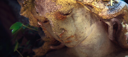 Beautiful sad angel. An ancient stone statue.