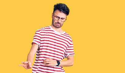 Young hispanic man wearing casual clothes disgusted expression, displeased and fearful doing...