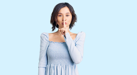Young beautiful girl wearing casual clothes asking to be quiet with finger on lips. silence and secret concept.